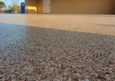 This image shows a garage floor applied with flake epoxy flooring