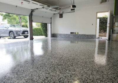 This image shows a garage floor applied with flake epoxy flooring