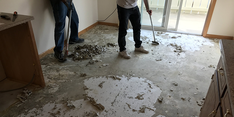This image shows me removing glue from floor.